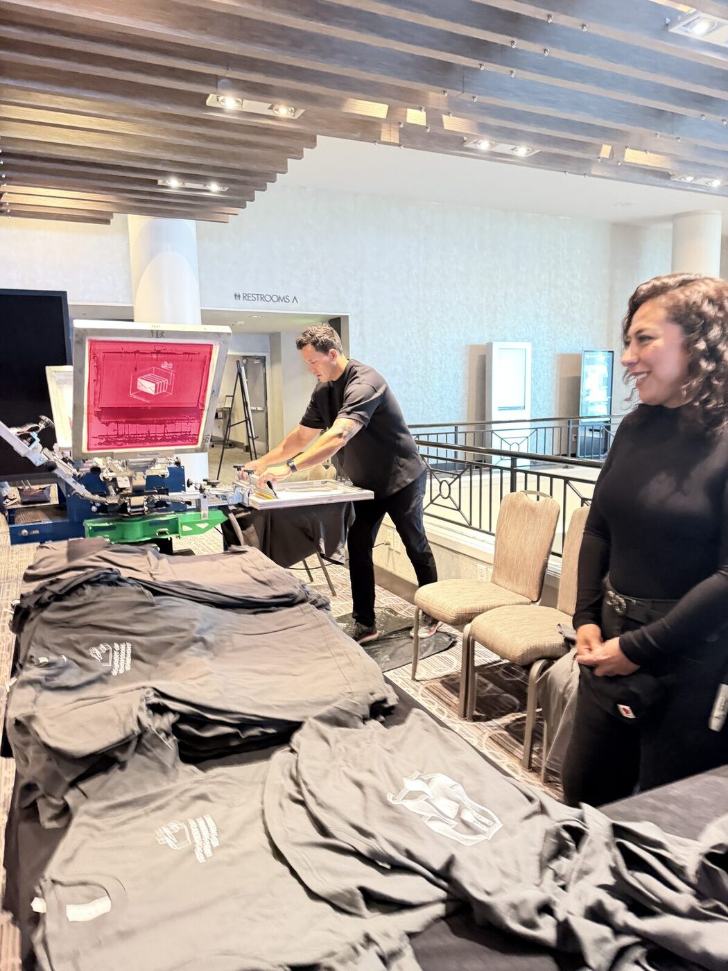 Operator running a live press at an event booth