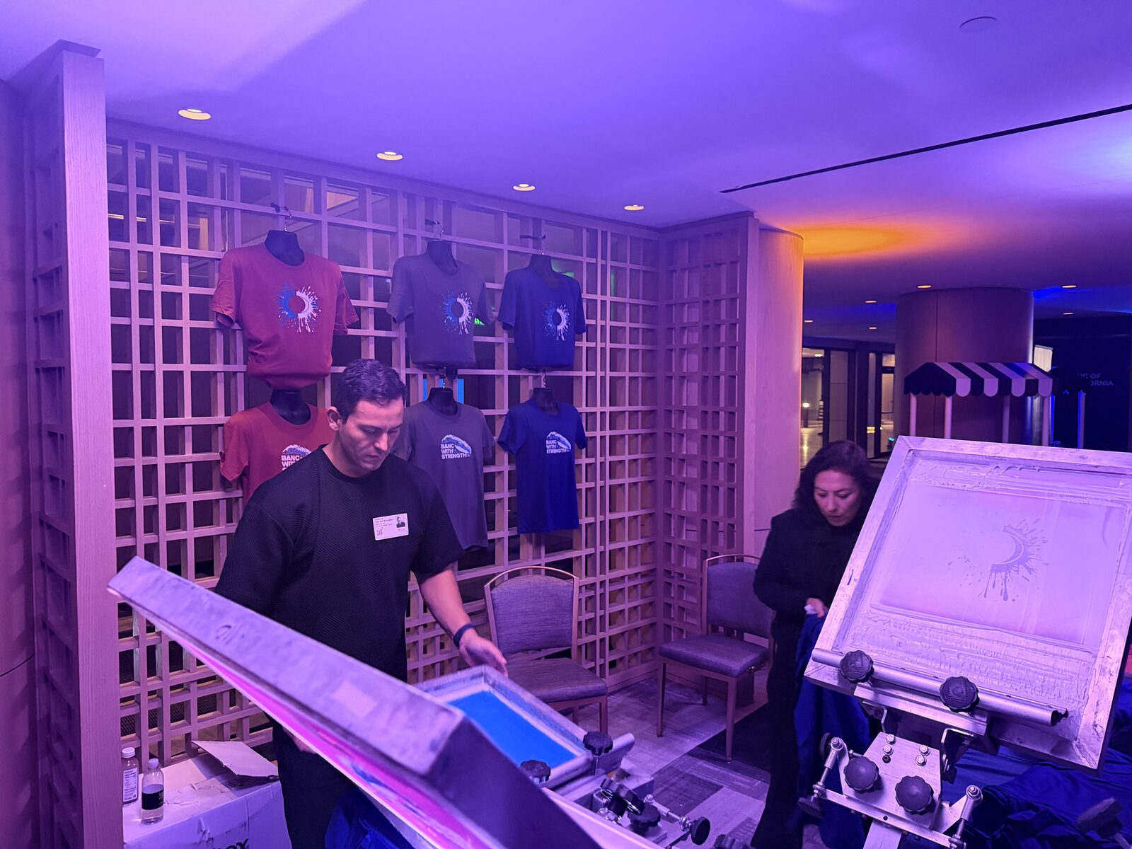 Event shirt wall showing finished custom pieces